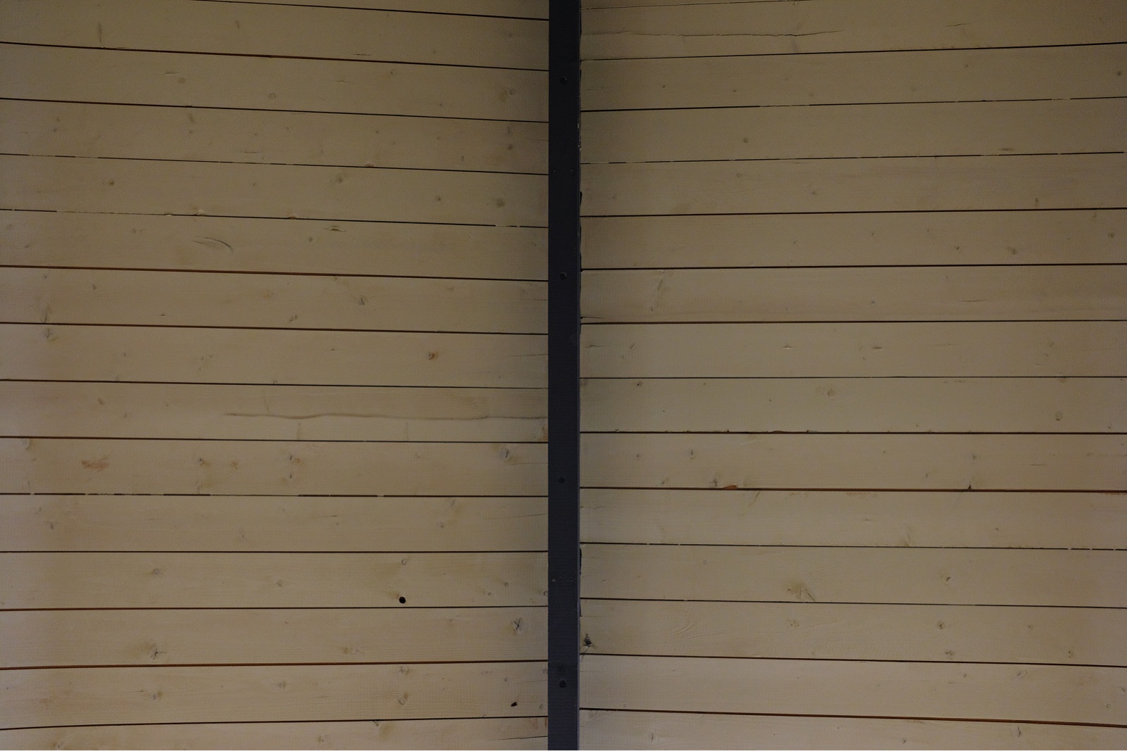 Photo taken looking up at the ceiling of a wooden summerhouse